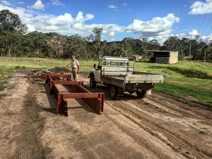 Steel frames for the first compost bays laid out beside the ute
