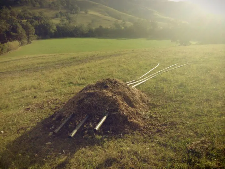A passive aerated compost windrow in a paddock at sunset